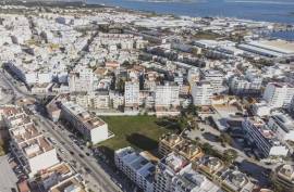 Urban land with 6430 m2 and approved PIP located next to Rotunda do Cubo in Olhão.