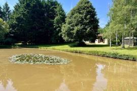 Detached riverside house with lake.