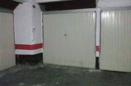 Large closed garage space with storage room and natural light.