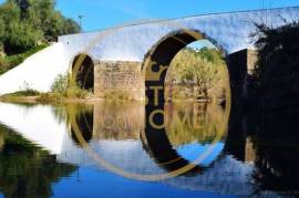 Located near the Roman bridge of Tôr, rustic land 1366 m2, contain a vegetable garden with 3 orange trees and 3 walnut trees, w / hole